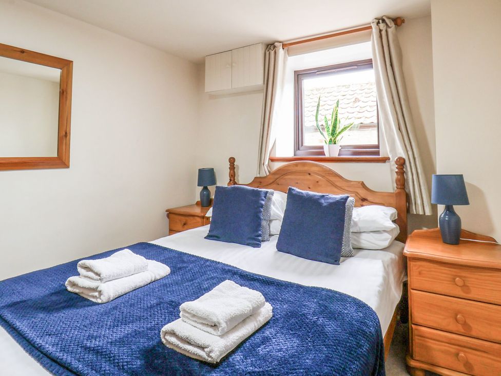 A bedroom with a double bed and bedside tables at Owl in Pickering