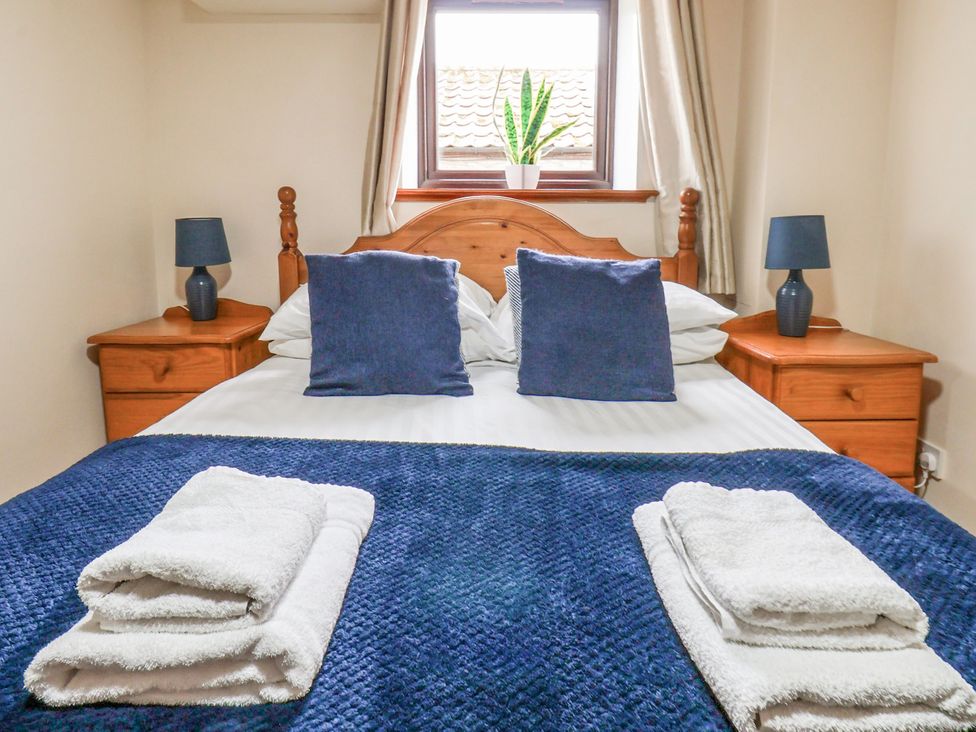 A bedroom with a double bed and bedside tables at Owl in Pickering