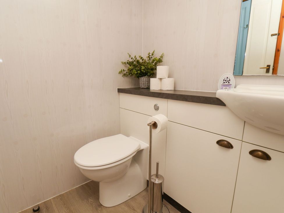 A bathroom with a toilet and sink at Owl in Pickering