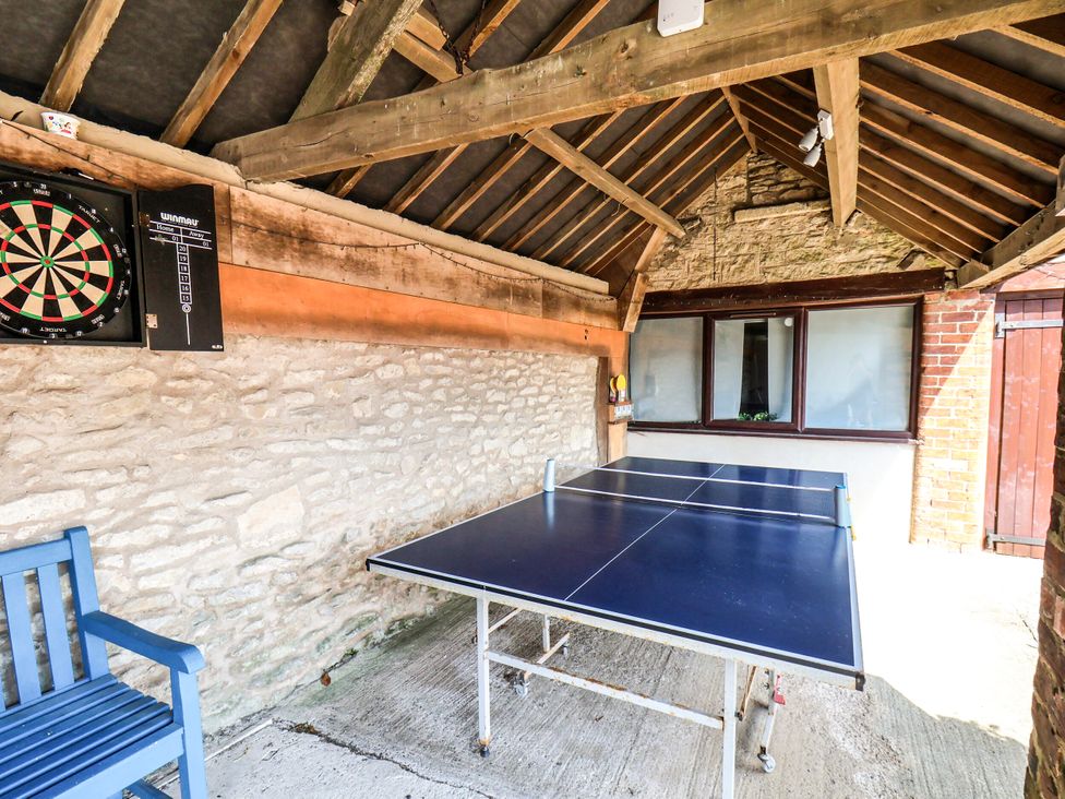 A games room with a dartboard and table tennis table at Owl in Pickering