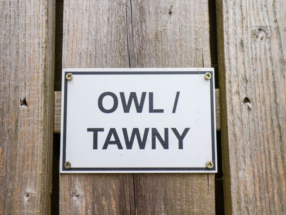 A sign indicating OWL / TAWNY at Owl in Pickering