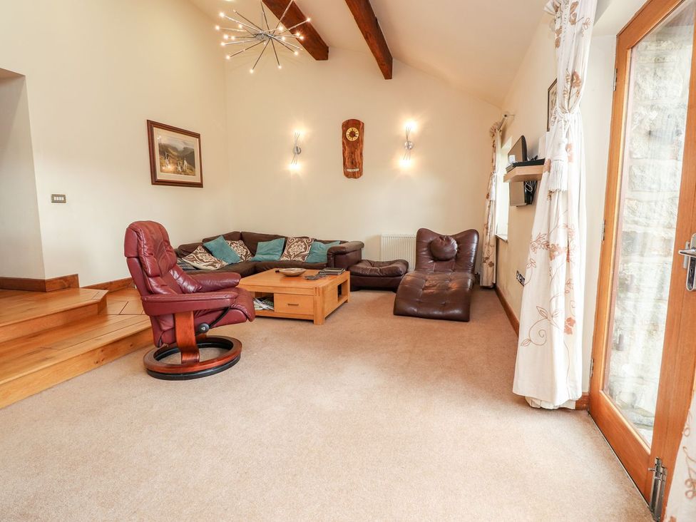 A living room with a sofa and coffee table at Shepherd's Barn Lancaster