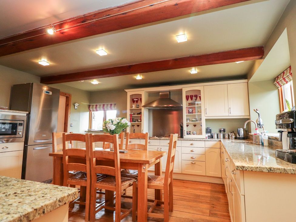 A kitchen with a table and chairs at Shepherd's Barn in Lancaster