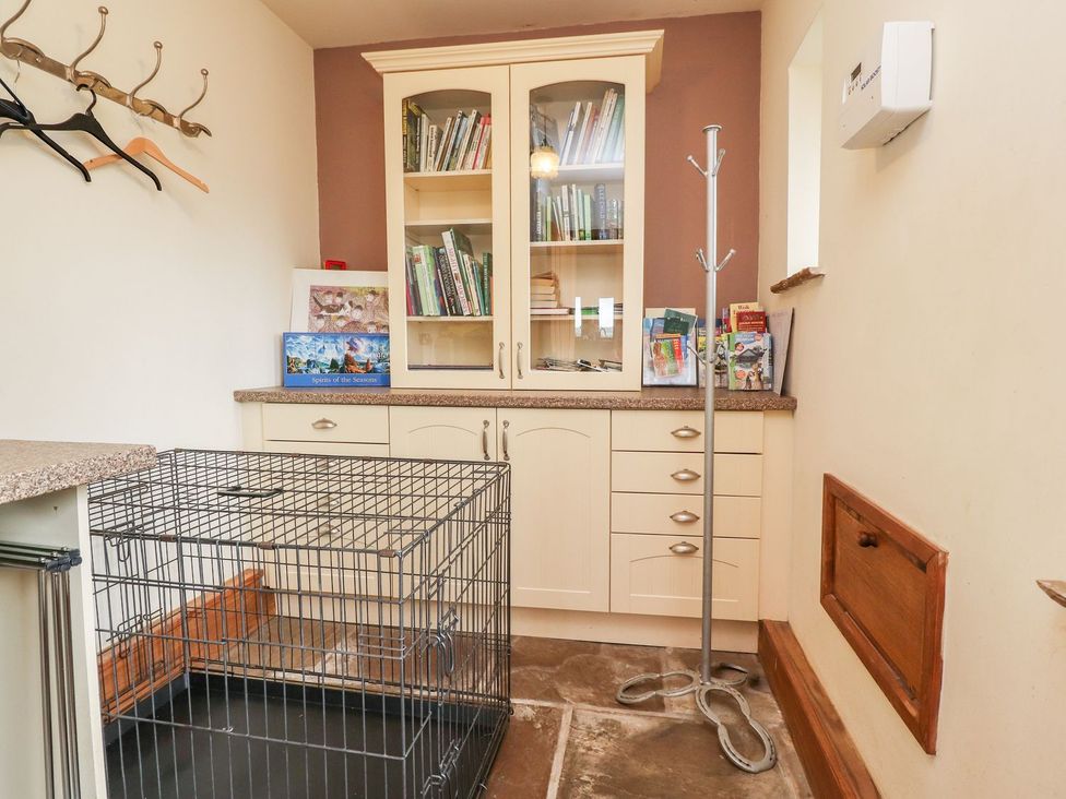A utility room featuring a bookshelf and cage at Shepherd's Barn Lancaster
