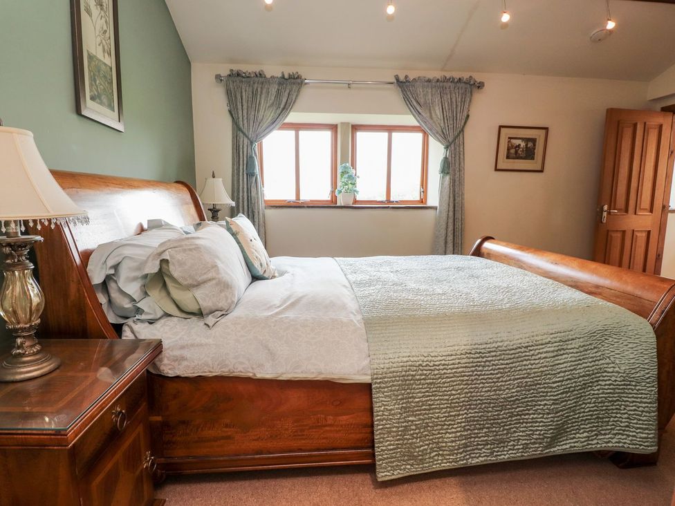 A bedroom with a bed and a window at Shepherd's Barn in Lancaster