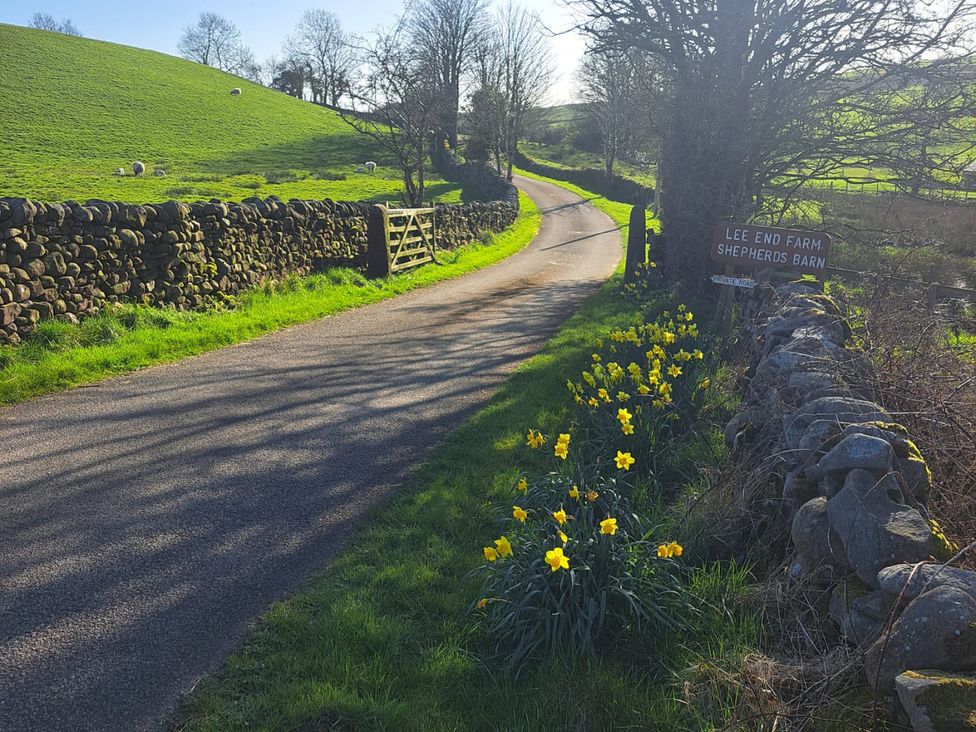 A road with a gate and sign at Shepherd's Barn in Lancaster