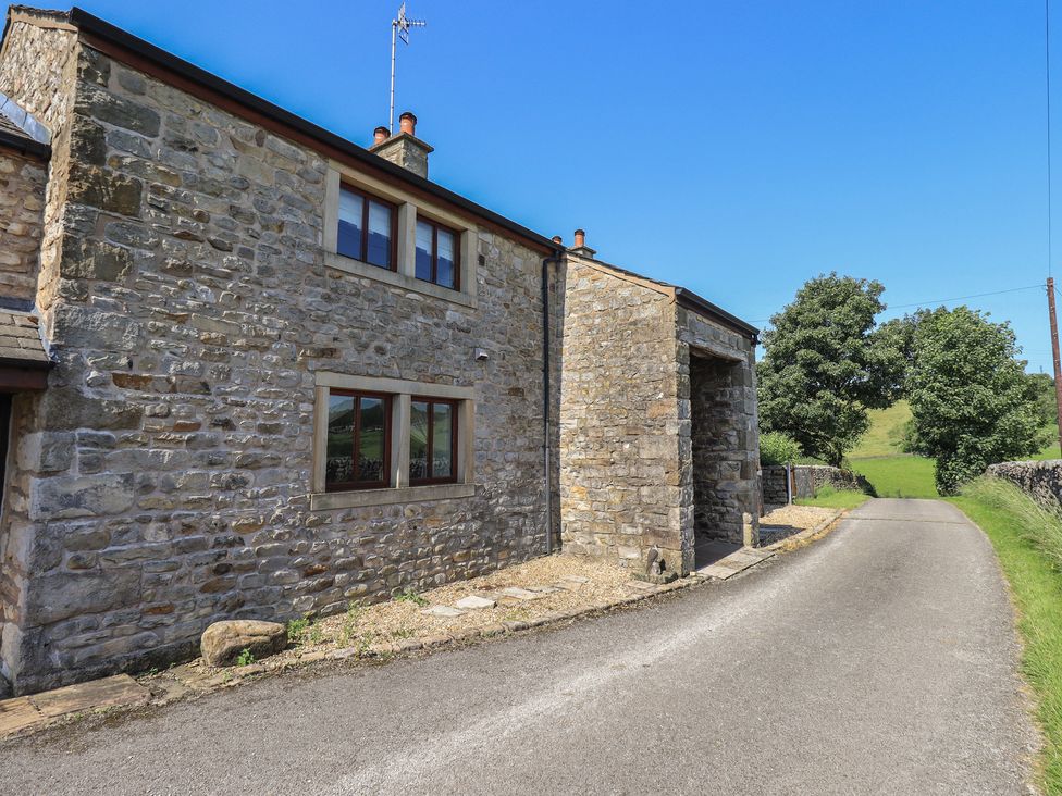 A stone building with windows beside a road at Shepherd's Barn in Lancaster