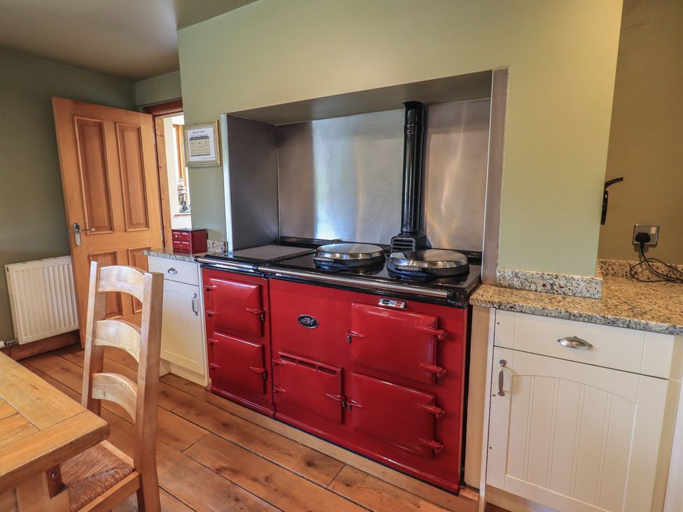 A kitchen with a red stove and oven at Shepherd's Barn in Lancaster