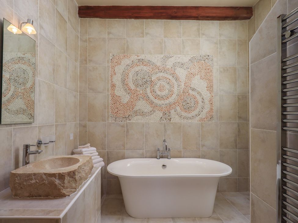 A bathroom with a bathtub and sink at Shepherd's Barn in Lancaster