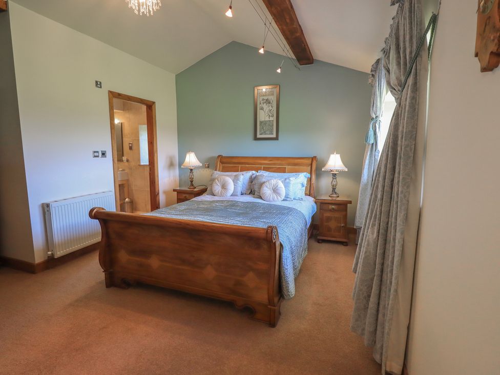 A bedroom with a bed and nightstand at Shepherd's Barn in Lancaster