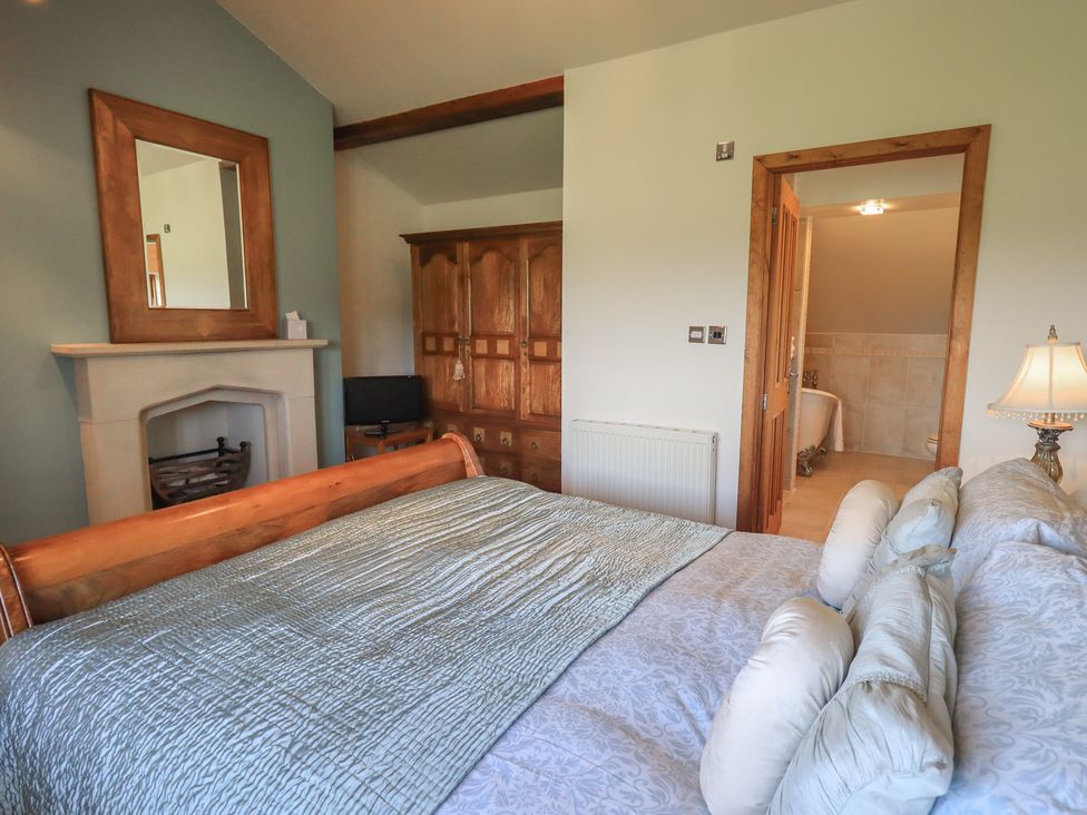 A bedroom with a bed and storage cabinet at Shepherd's Barn in Lancaster
