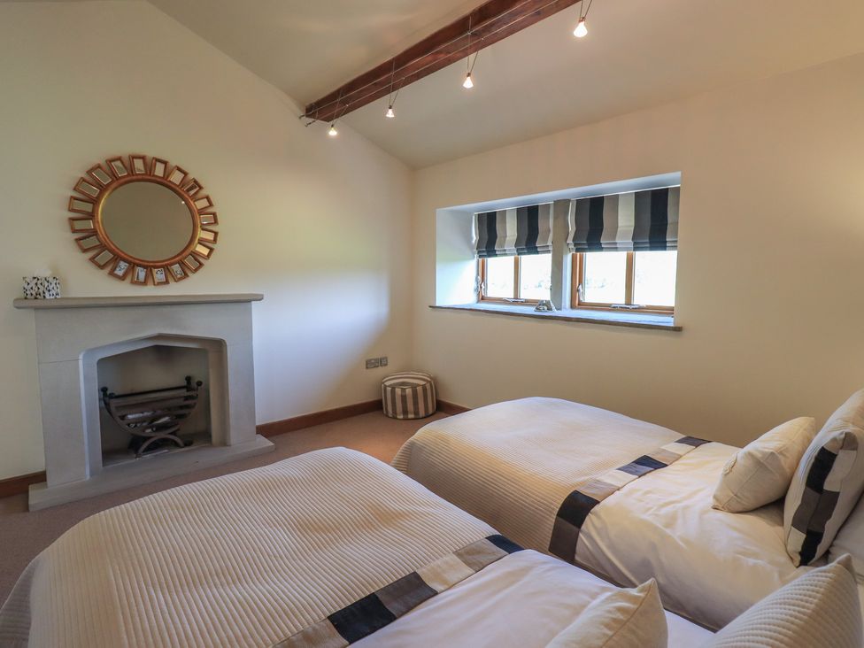 A bedroom with twin beds and a fireplace at Shepherd's Barn in Lancaster
