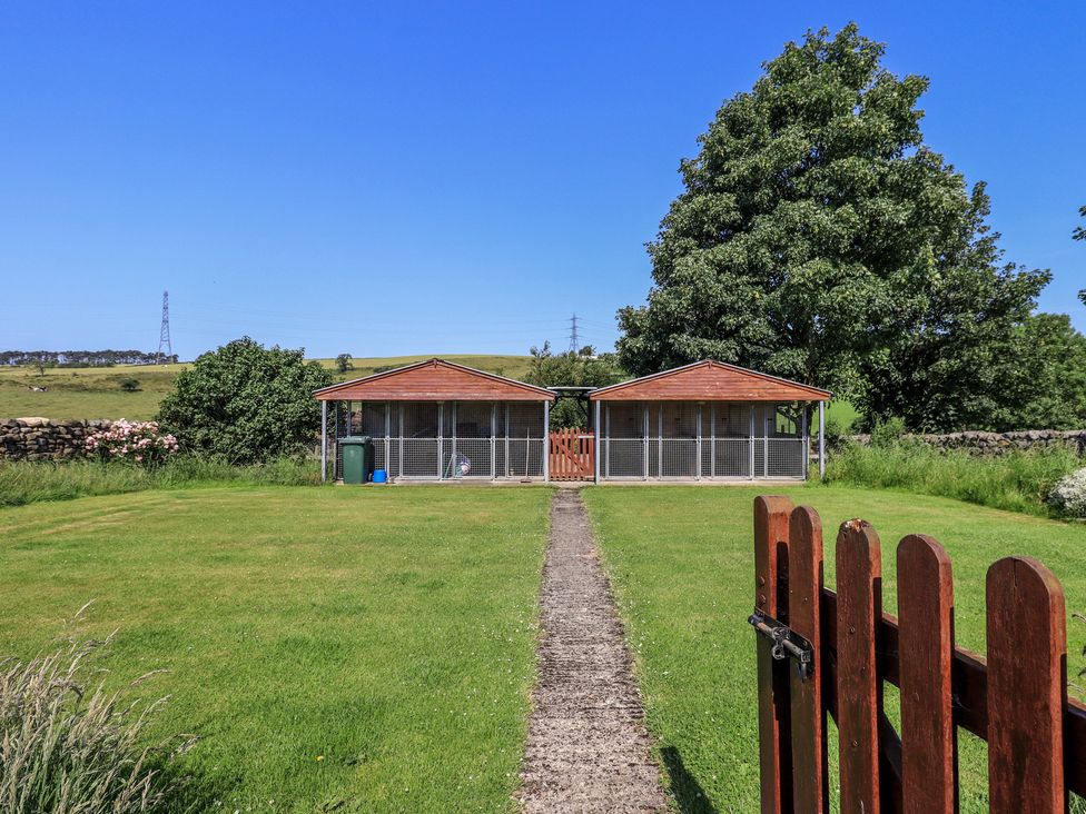 An outdoor area with two outbuildings and a path at Shepherd's Barn in Lancaster
