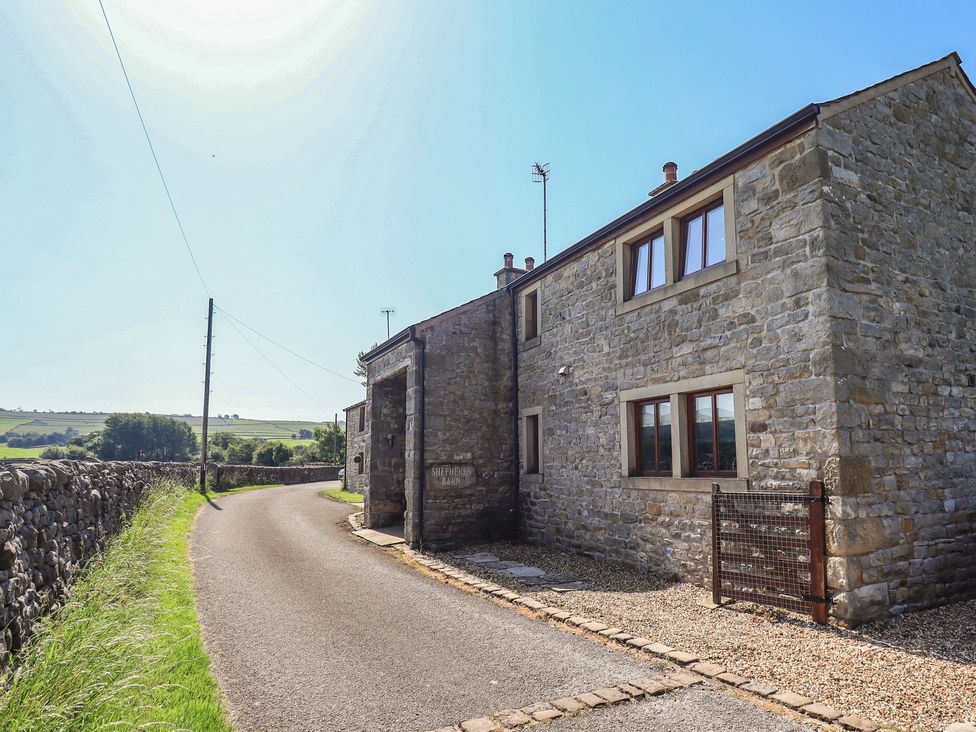 A stone building beside a gravel path at Shepherd's Barn in Lancaster