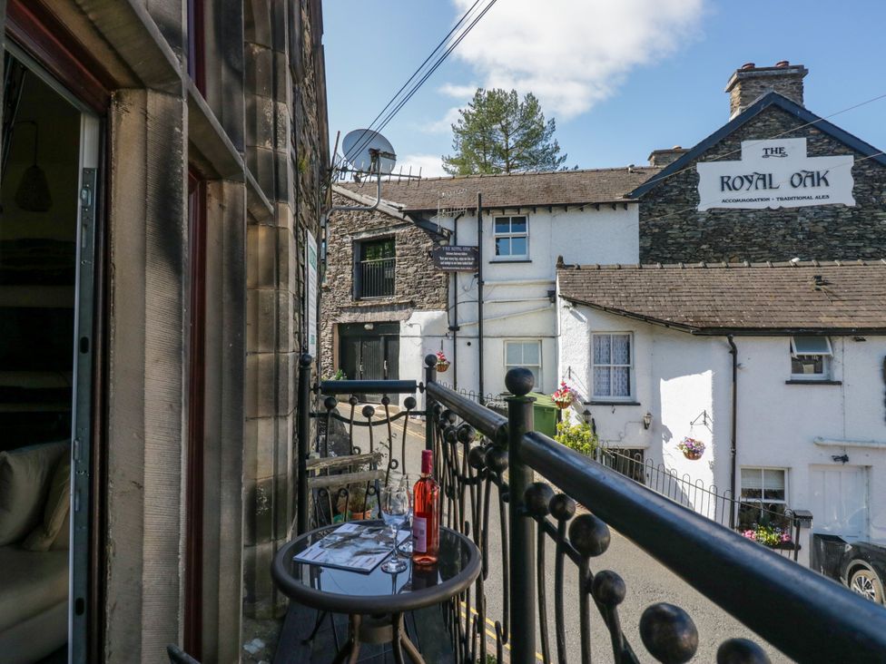 A balcony with a table and glass in front of The Royal Oak in Bowness-On-Windermere