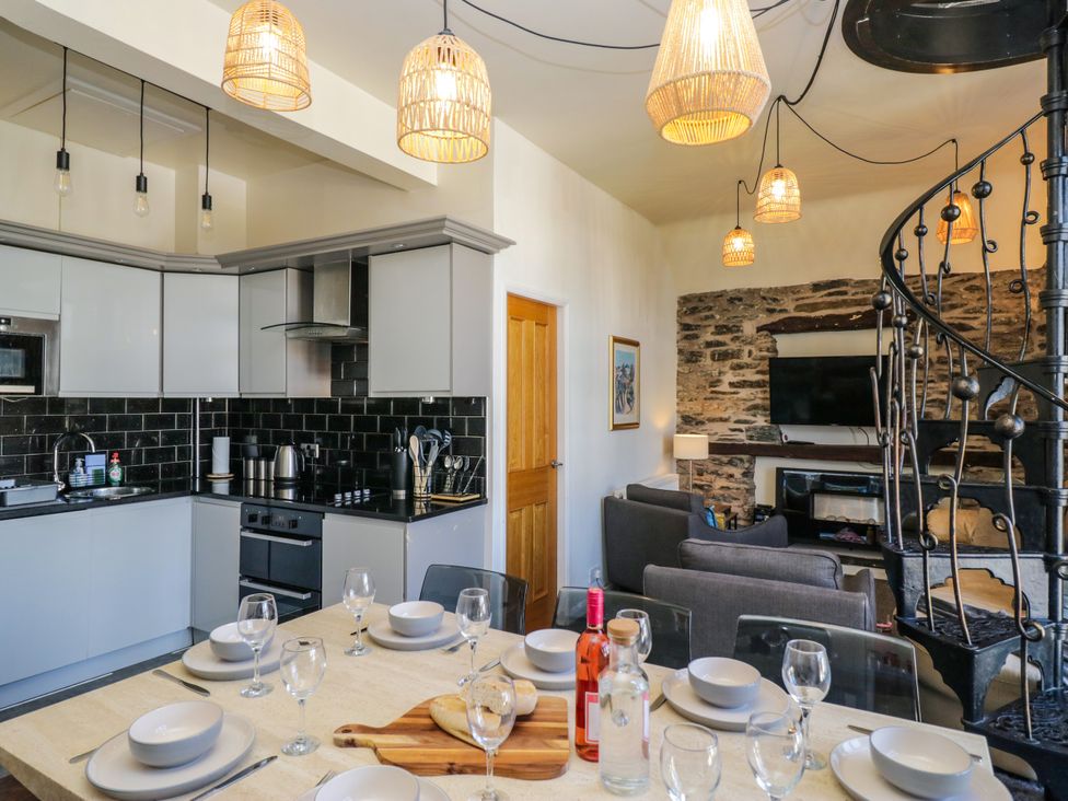 A kitchen with a dining table set at Hillside Cottage in Bowness-On-Windermere