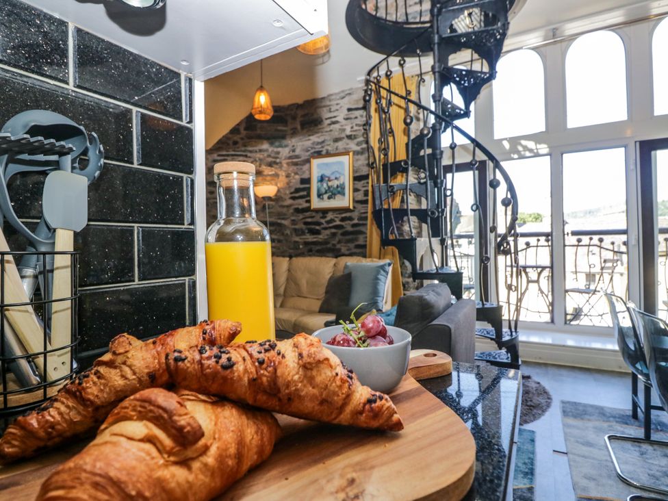 A kitchen with croissants and juice bottle at Hillside Cottage Bowness-On-Windermere