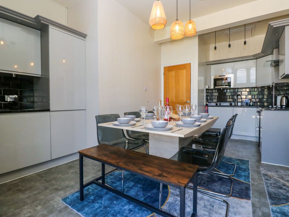 A dining room with a table set for a meal at Hillside Cottage in Bowness-On-Windermere