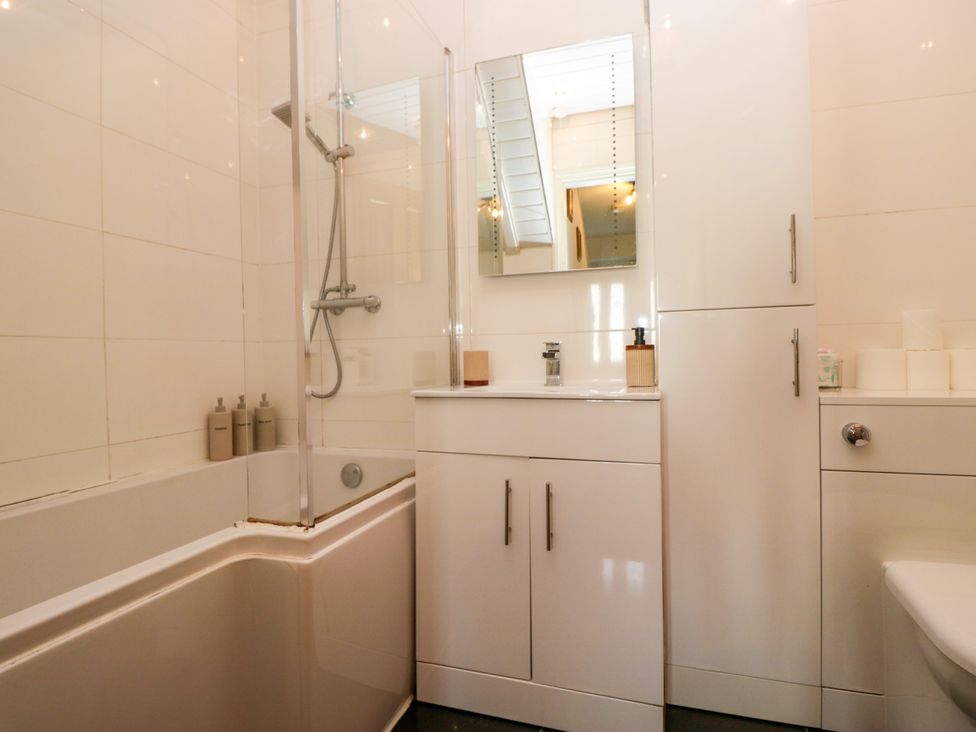 A bathroom with a bathtub and shower at Hillside Cottage in Bowness-On-Windermere