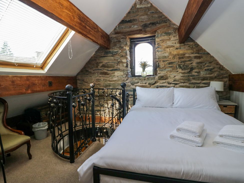 A bedroom with a bed and a window at Hillside Cottage Bowness-On-Windermere