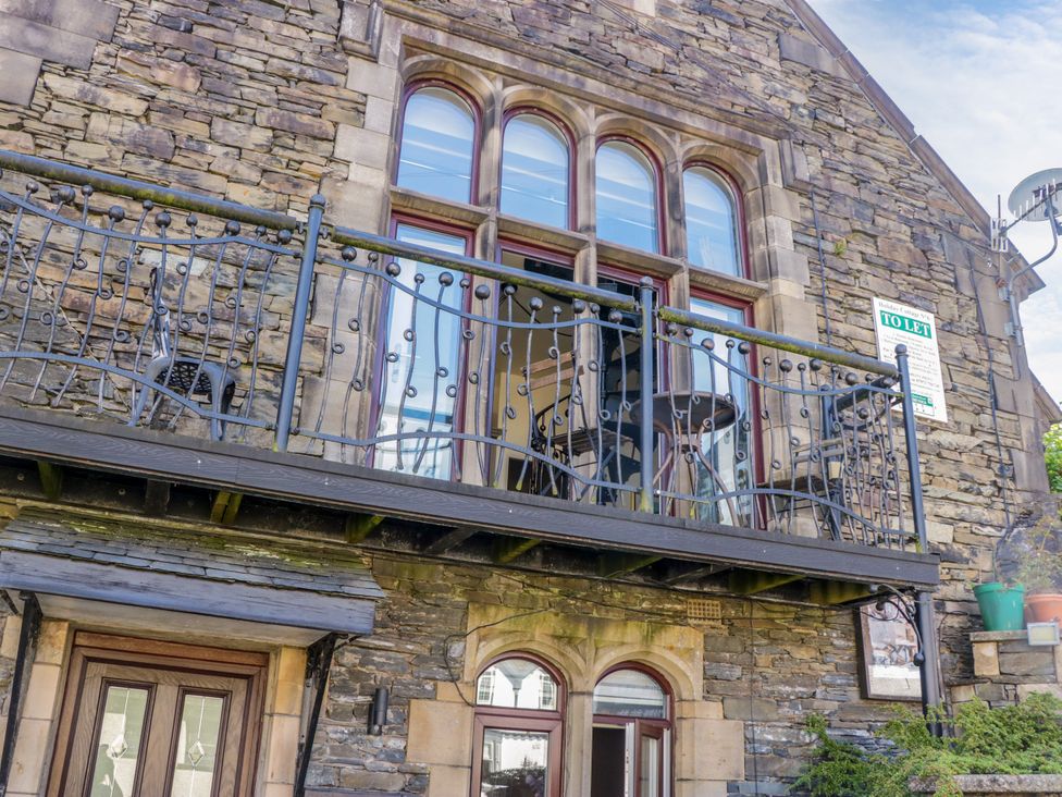 A balcony with table and chairs at Hillside Cottage in Bowness-On-Windermere