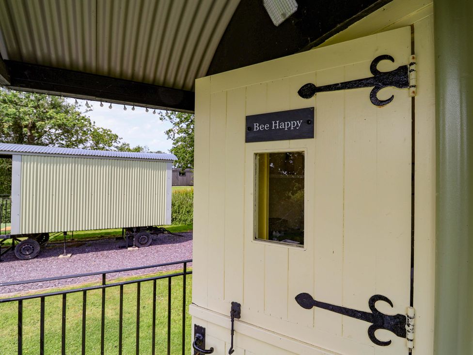 A door with a window and sign at Bee Happy in Whitchurch