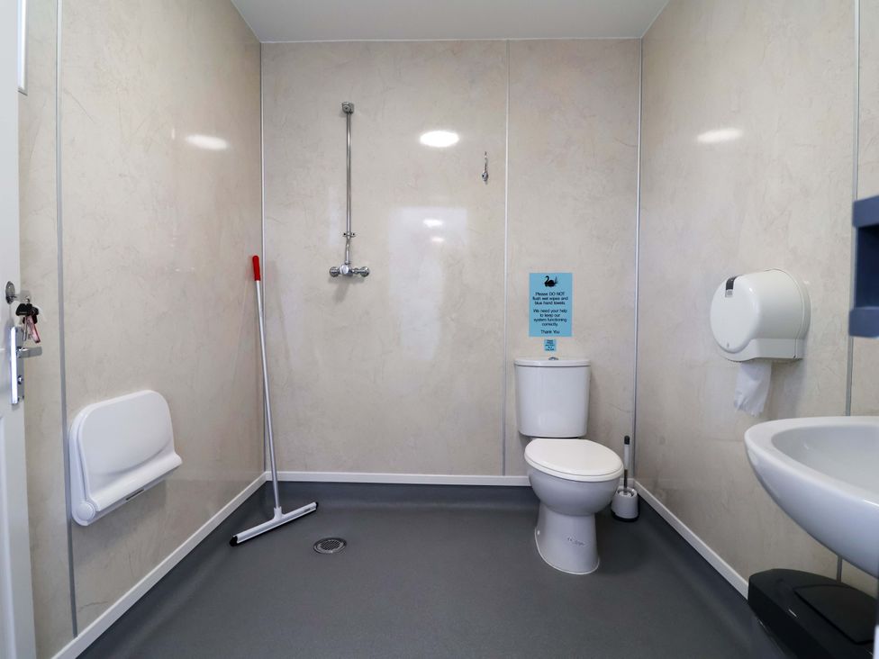 A bathroom with a toilet, sink, and shower at Bee Happy in Whitchurch