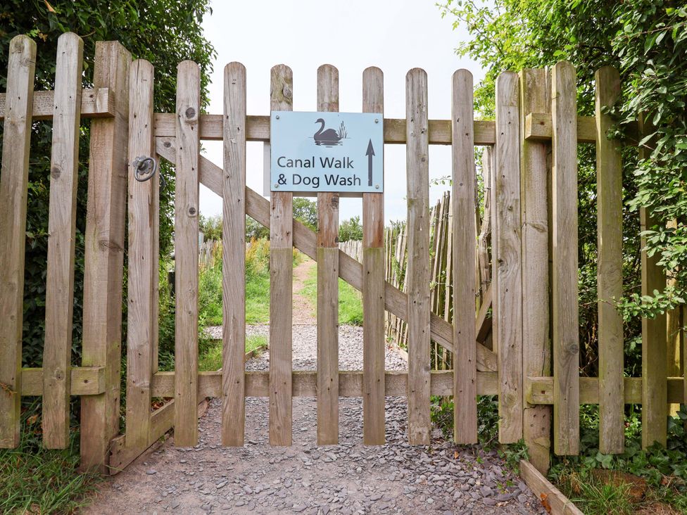 A gate with a sign for Canal Walk and Dog Wash