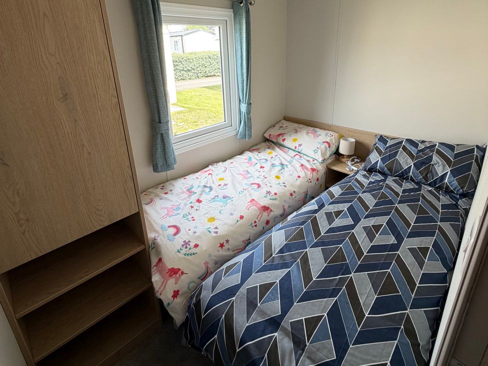 A bedroom with two beds and a window at Trecco bay holiday park- Magnolia 11 Porthcawl