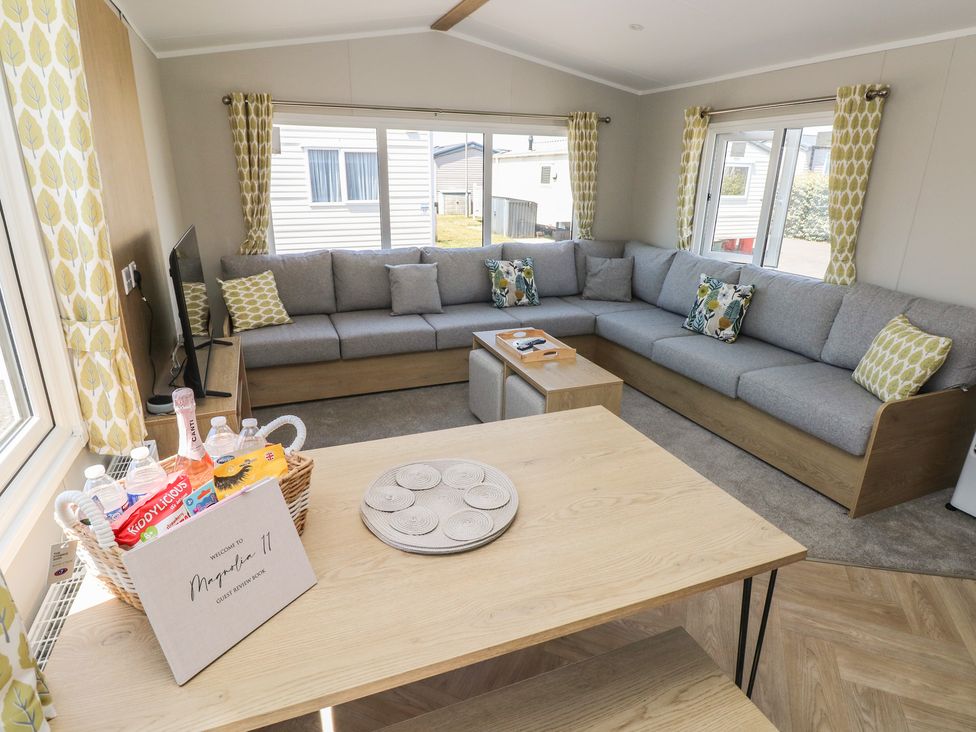 A living room with a sofa and coffee table at Trecco Bay Holiday Park - Magnolia 11 Porthcawl