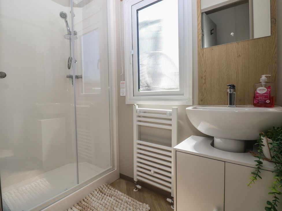 A bathroom with a shower and sink at Trecco Bay Holiday Park - Magnolia 11 Porthcawl