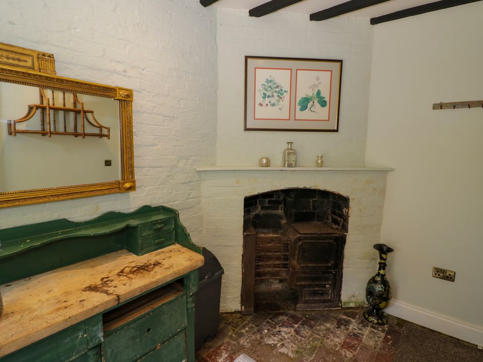 A room with a mirror and a fireplace at The Stable Flat 