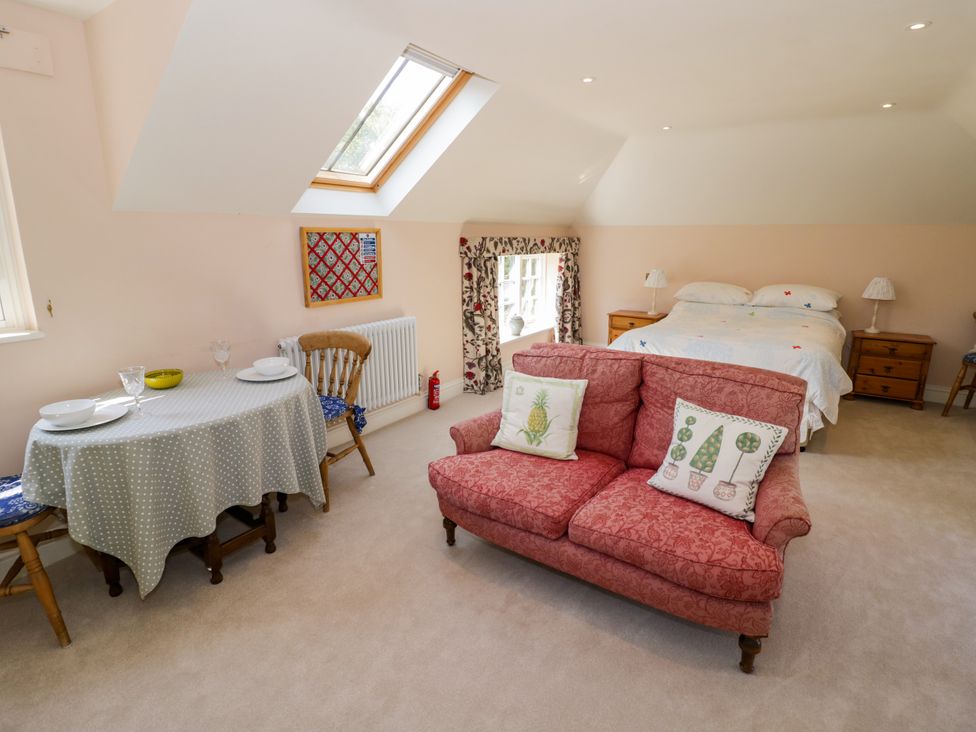 A bedroom with a sofa and a bed at The Stable Flat 
