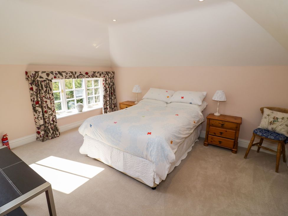A bedroom with a bed and window at The Stable Flat in 