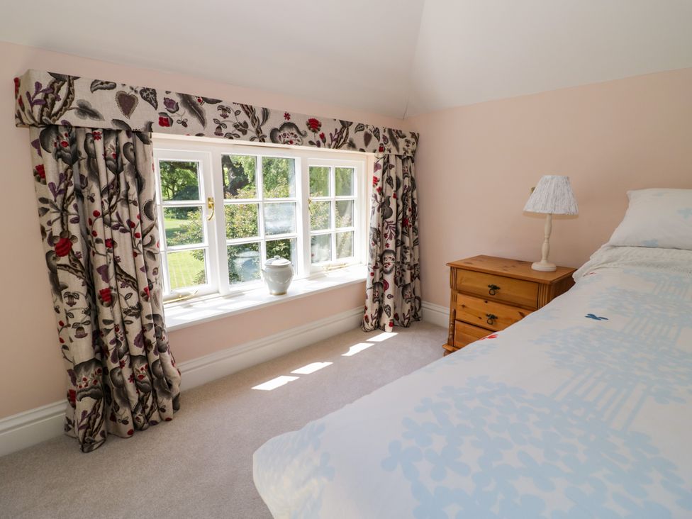 A bedroom with a bed and a window at The Stable Flat 