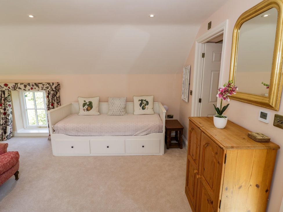 A bedroom with a bed and a dresser at The Stable Flat in 