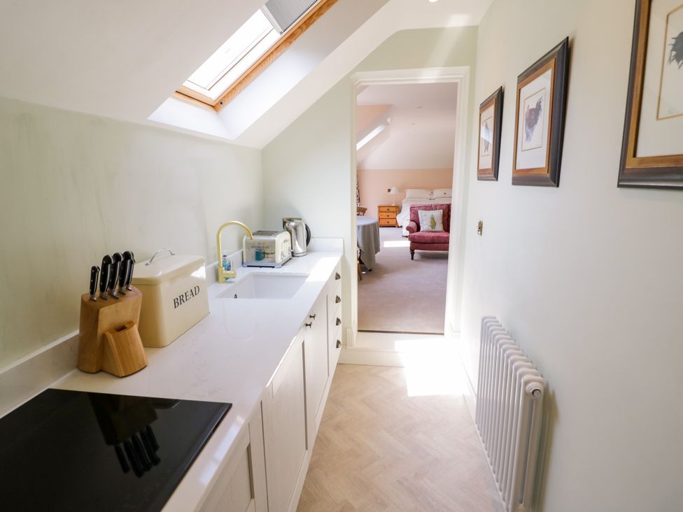 A kitchen with a sink and bread bin at The Stable Flat 