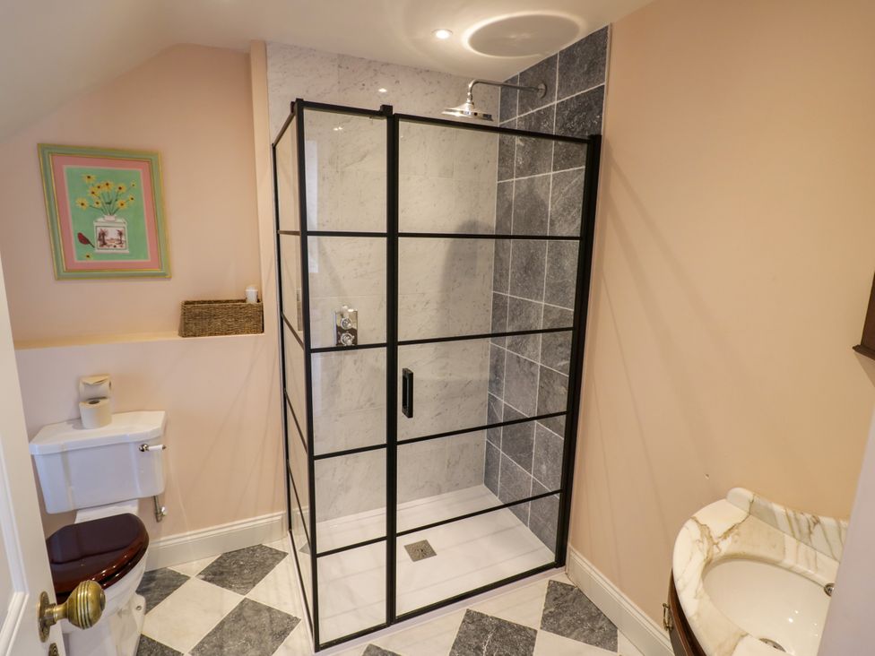 A bathroom with a shower, toilet, and sink at The Stable Flat in 