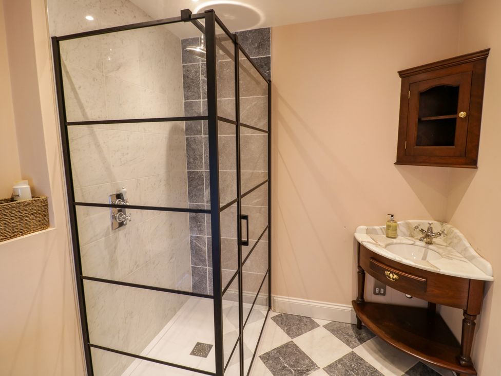 A bathroom with a shower and sink at The Stable Flat