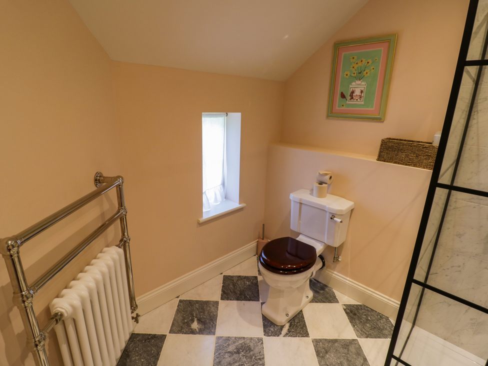 A bathroom with a toilet and towel rail at The Stable Flat