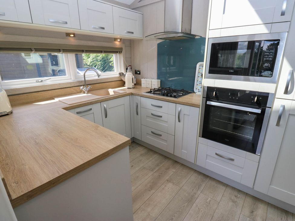 A kitchen with a sink and appliances at Dales Retreat in Threshfield near Grassington