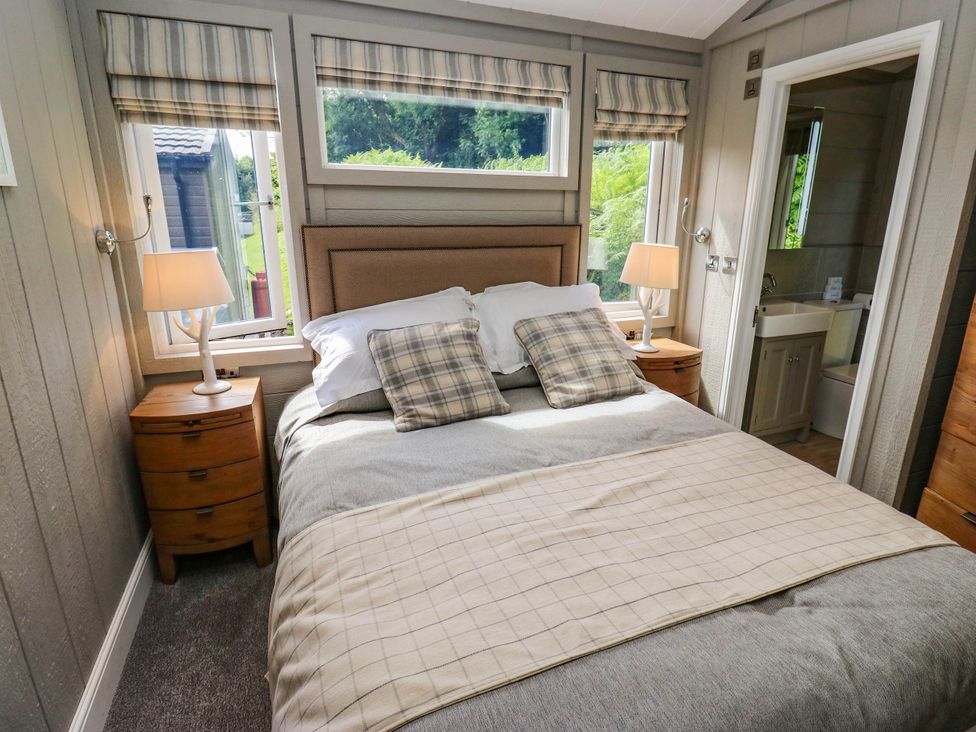 A bedroom with a bed and bedside table at Dales Retreat Threshfield near Grassington