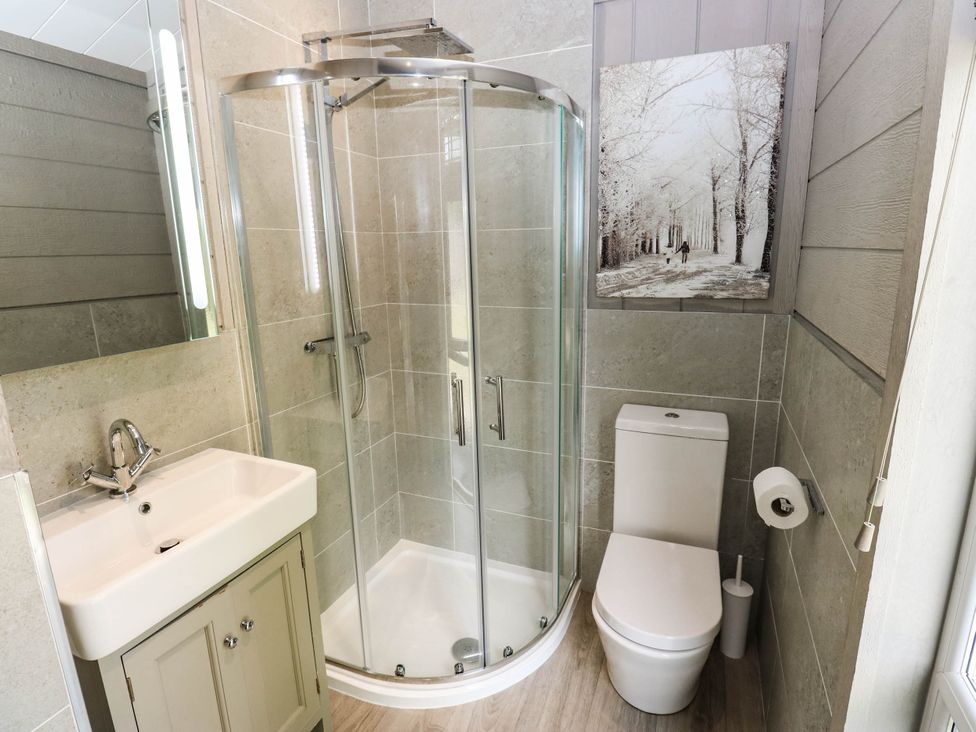 A bathroom with a shower and sink at Dales Retreat Threshfield near Grassington
