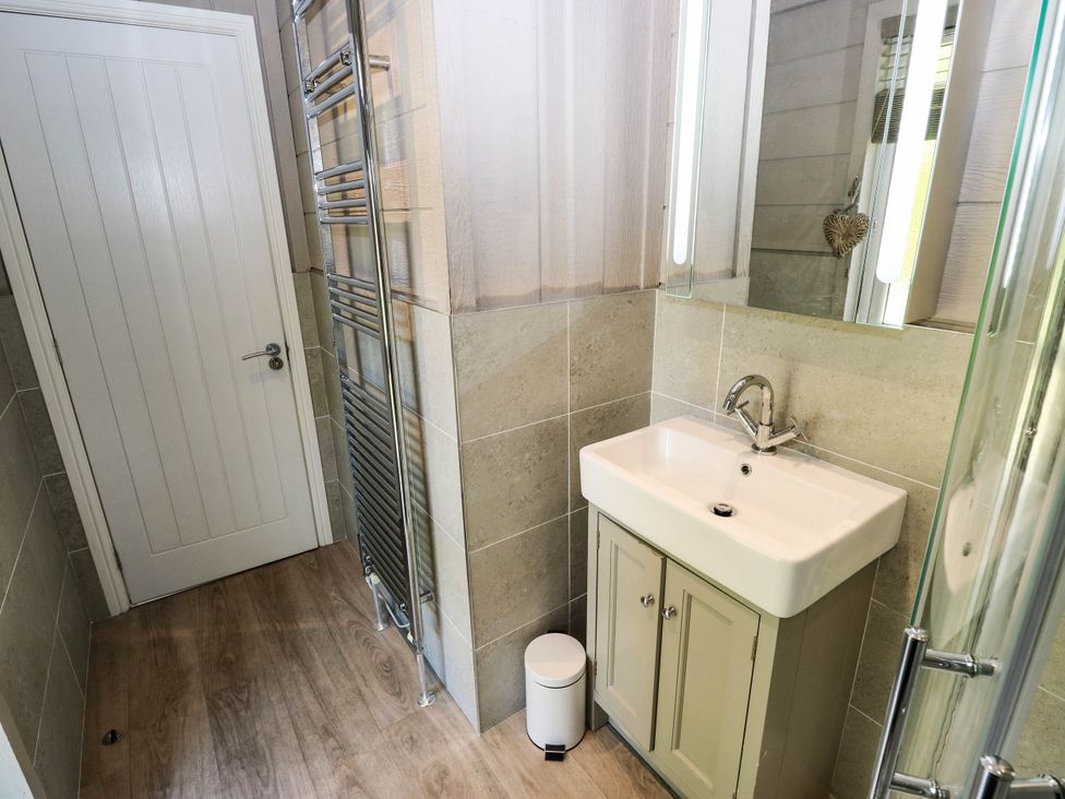 A bathroom with a sink and towel radiator at Dales Retreat Threshfield near Grassington