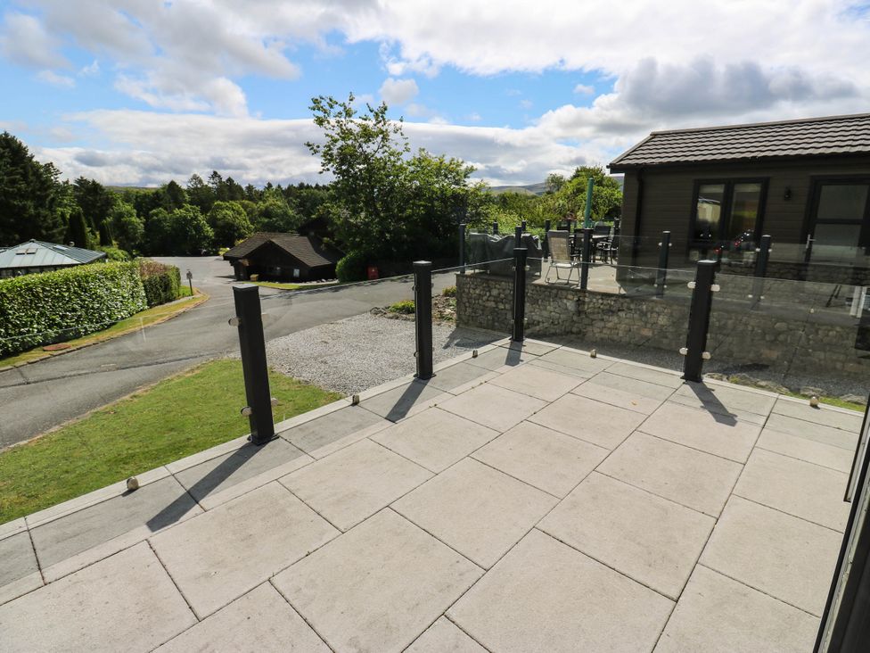 An outdoor patio area with a glass railing at Dales Retreat Threshfield near Grassington