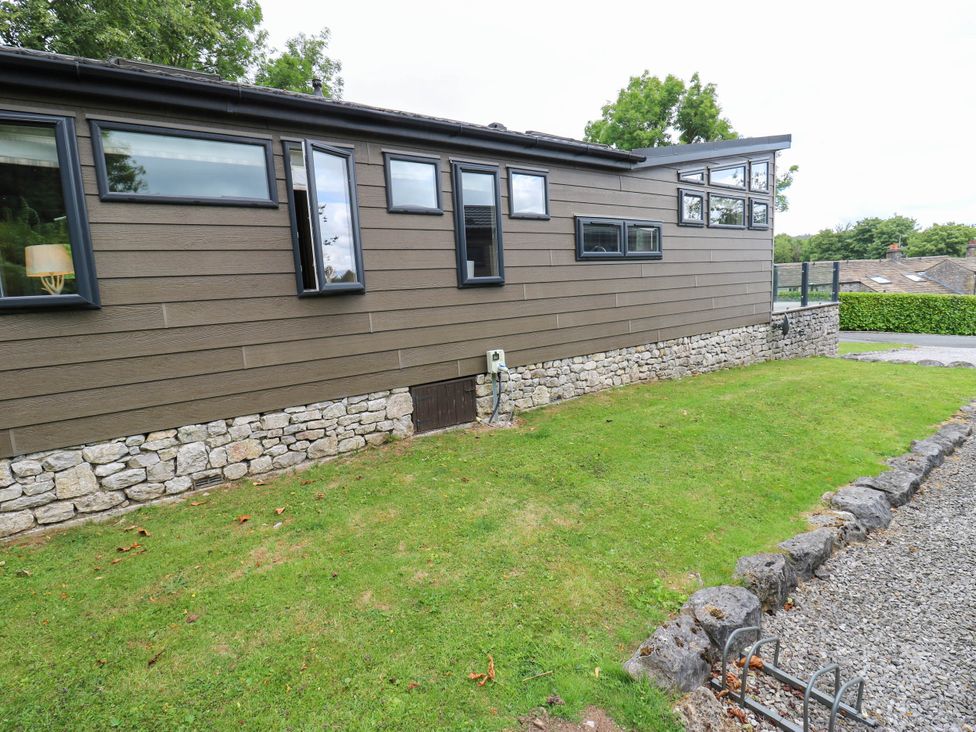 An exterior view of a building with windows and grass at Dales Retreat in Threshfield near Grassington