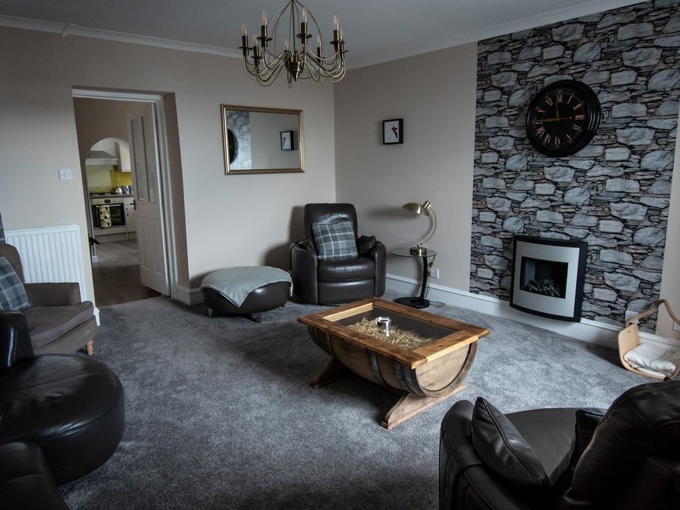 A living room with a coffee table and a fireplace at The Old Barn in Manchester