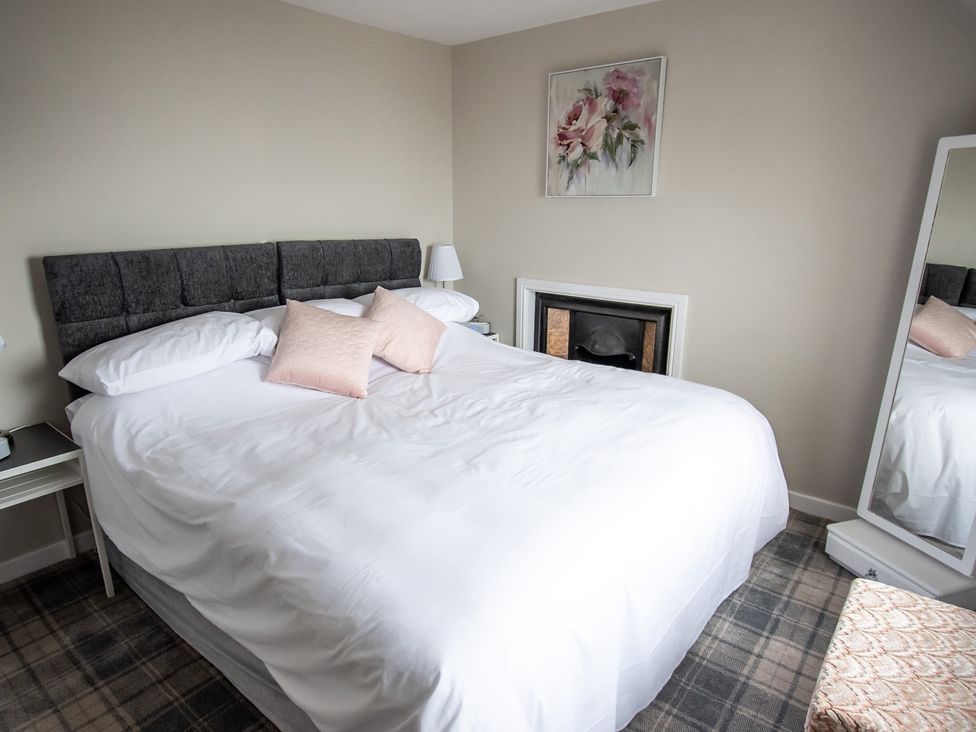 A bedroom with a bed and mirror at The Old Barn in Manchester