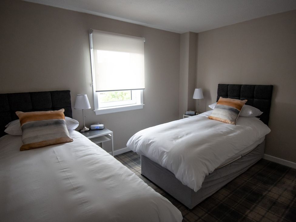 A bedroom with two beds and a window at 