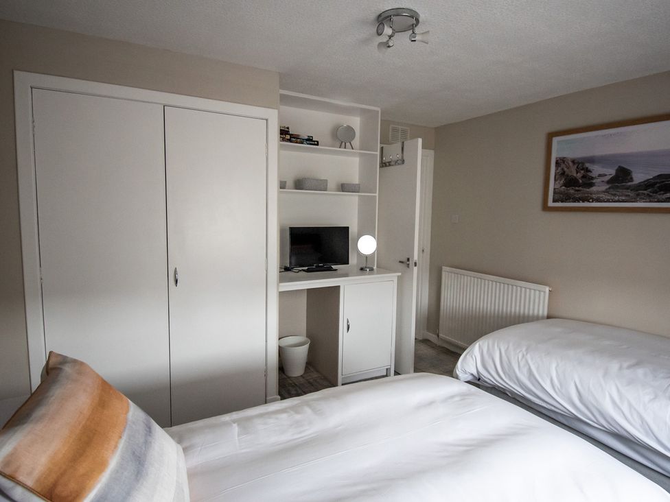 A bedroom with two beds and a desk at The Old Barn in Manchester